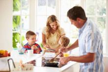 Happy family eating breakfast together 